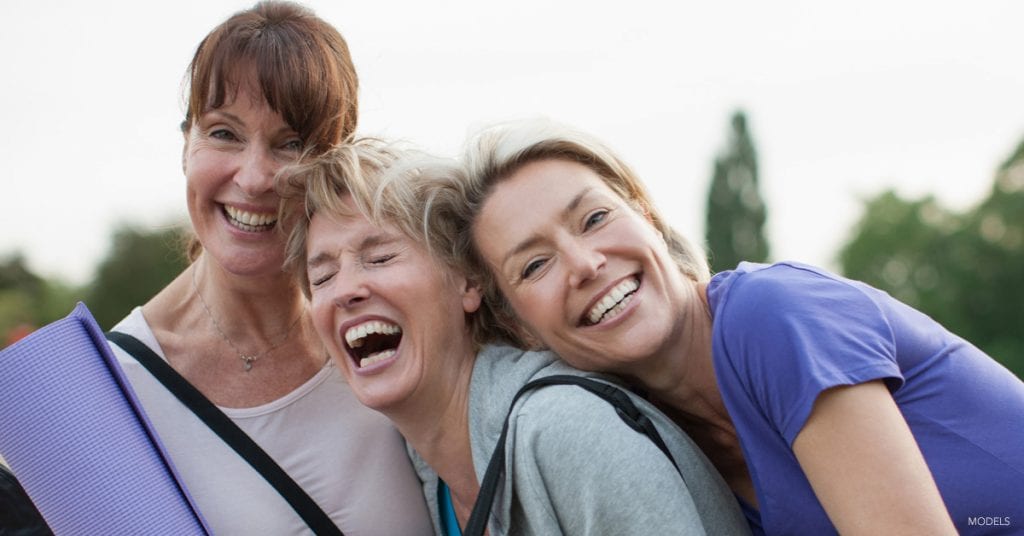 3 women considering the benefits of mommy makeover.