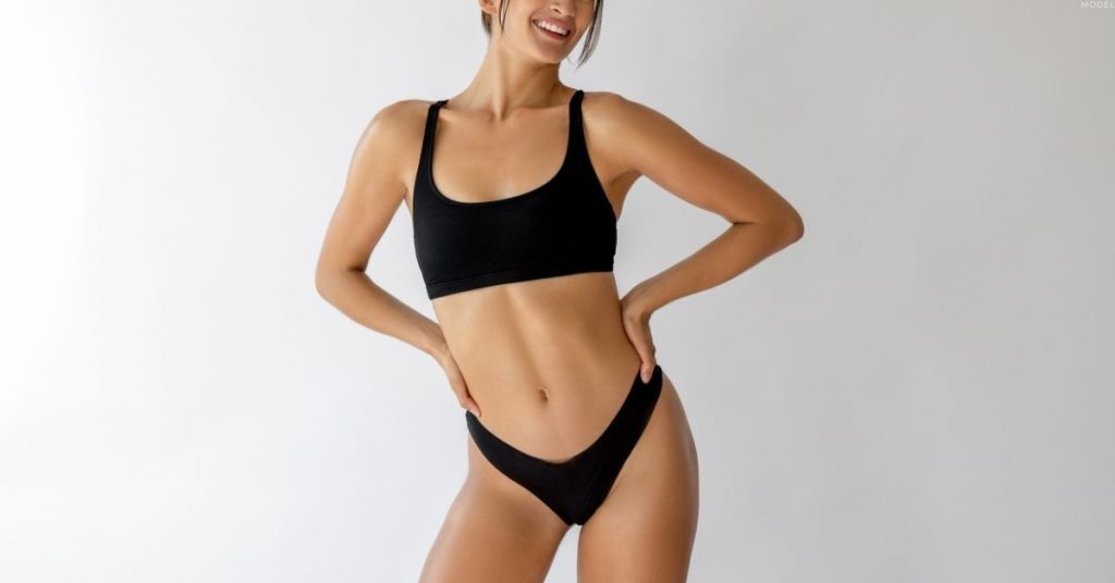 Smiling woman wearing black lingerie (model)